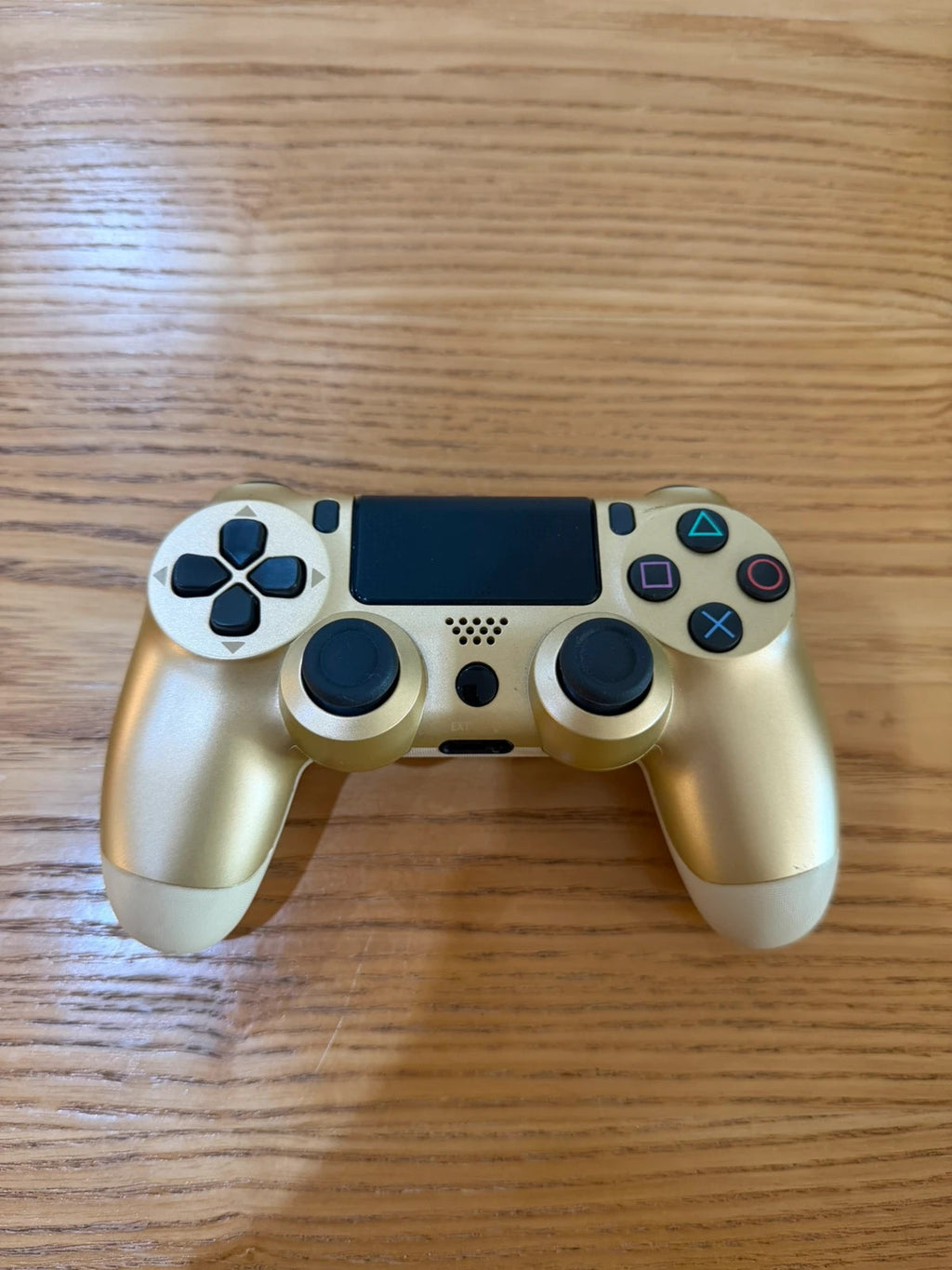 Third Party gold PlayStation 4 controller with wireless design and sleek finish.