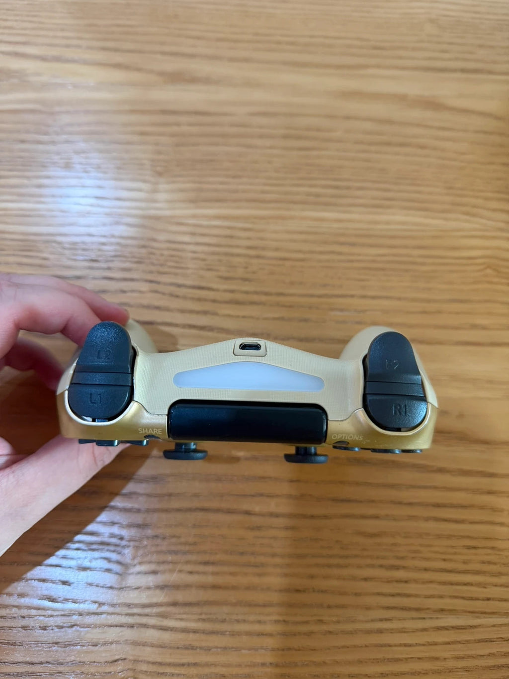 Third Party gold PlayStation 4 controller with wireless design and sleek finish.
