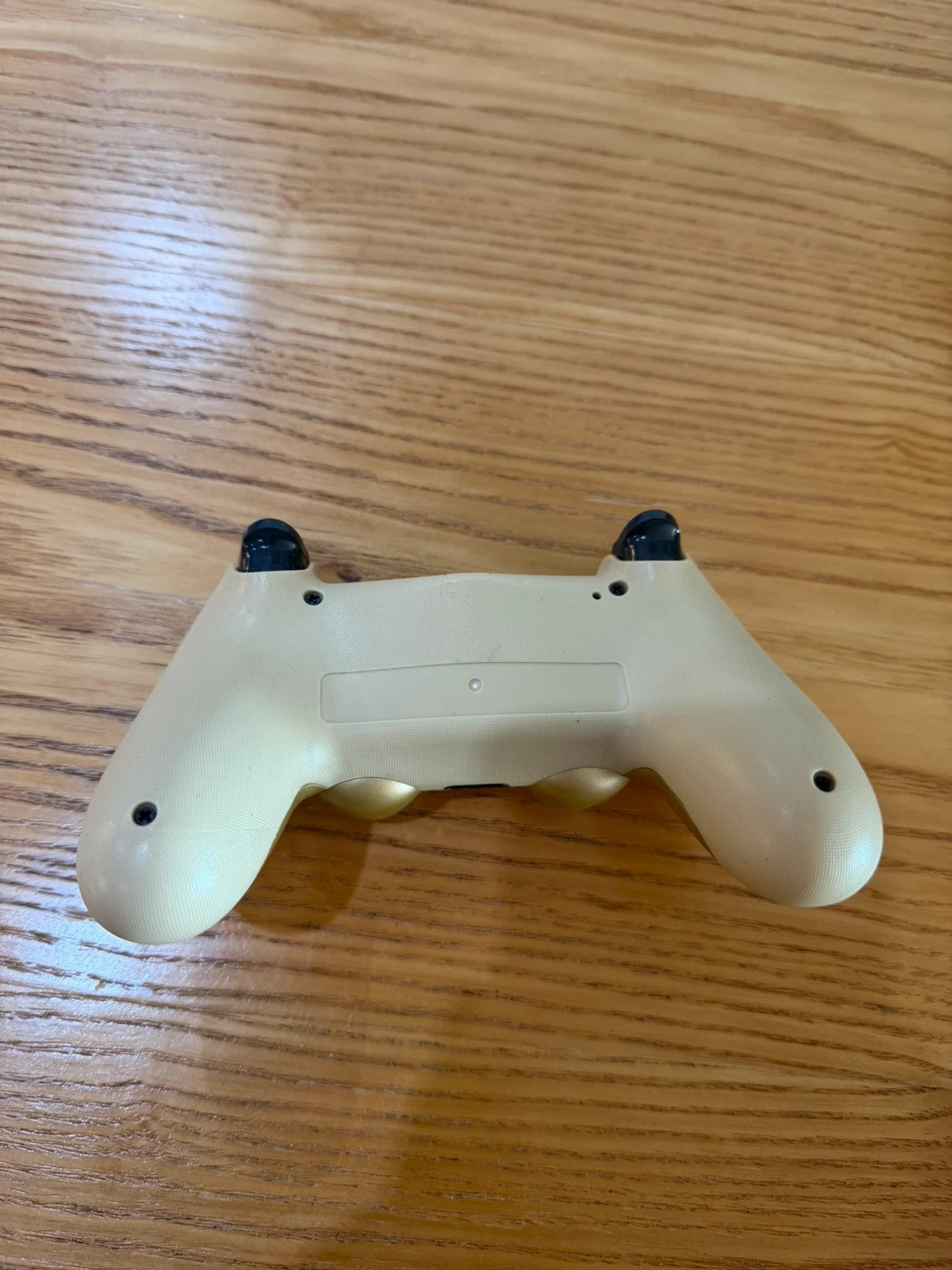 Third Party gold PlayStation 4 controller with wireless design and sleek finish.
