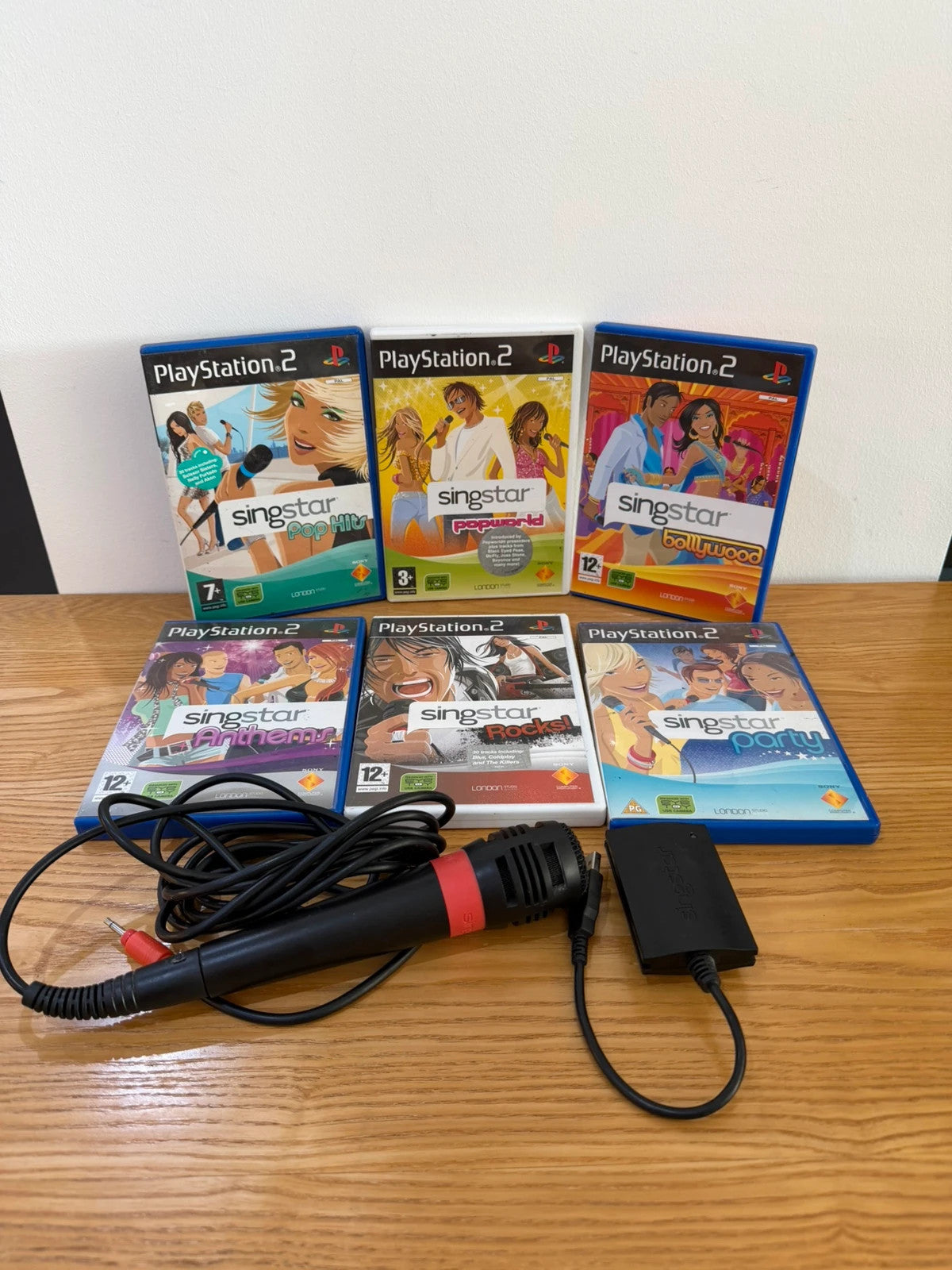 Wills SingStar bundle for PlayStation 2 with six games, microphone, and USB adapter.