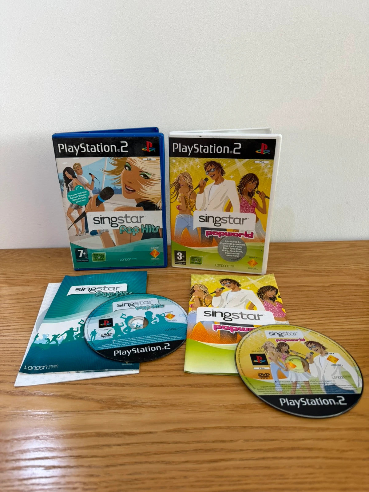 Wills SingStar bundle for PlayStation 2 with six games, microphone, and USB adapter.