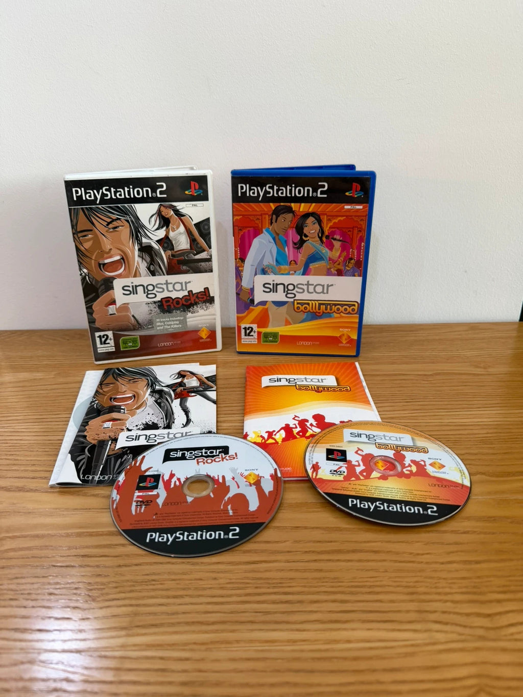 Wills SingStar bundle for PlayStation 2 with six games, microphone, and USB adapter.