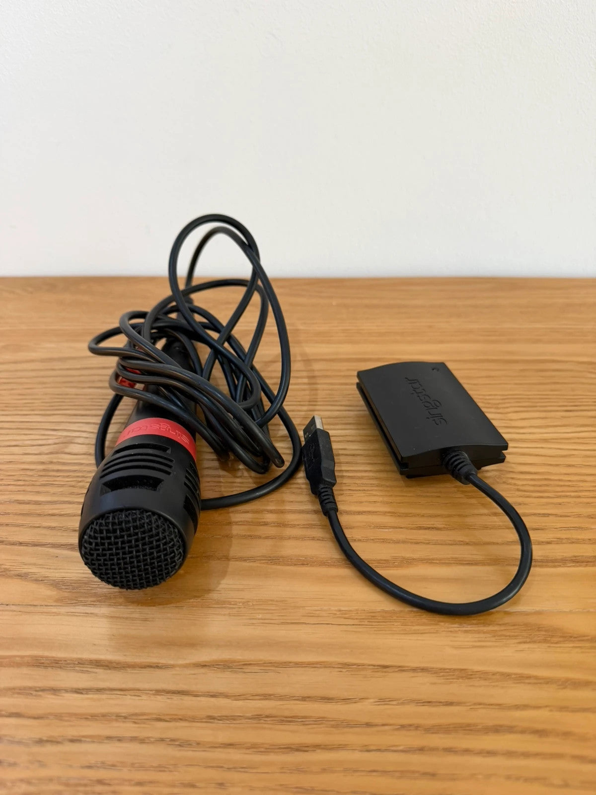 Wills SingStar bundle for PlayStation 2 with six games, microphone, and USB adapter.