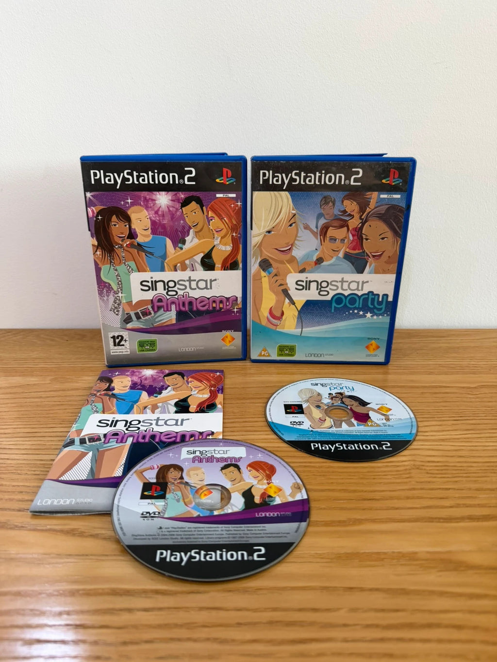 Wills SingStar bundle for PlayStation 2 with six games, microphone, and USB adapter.