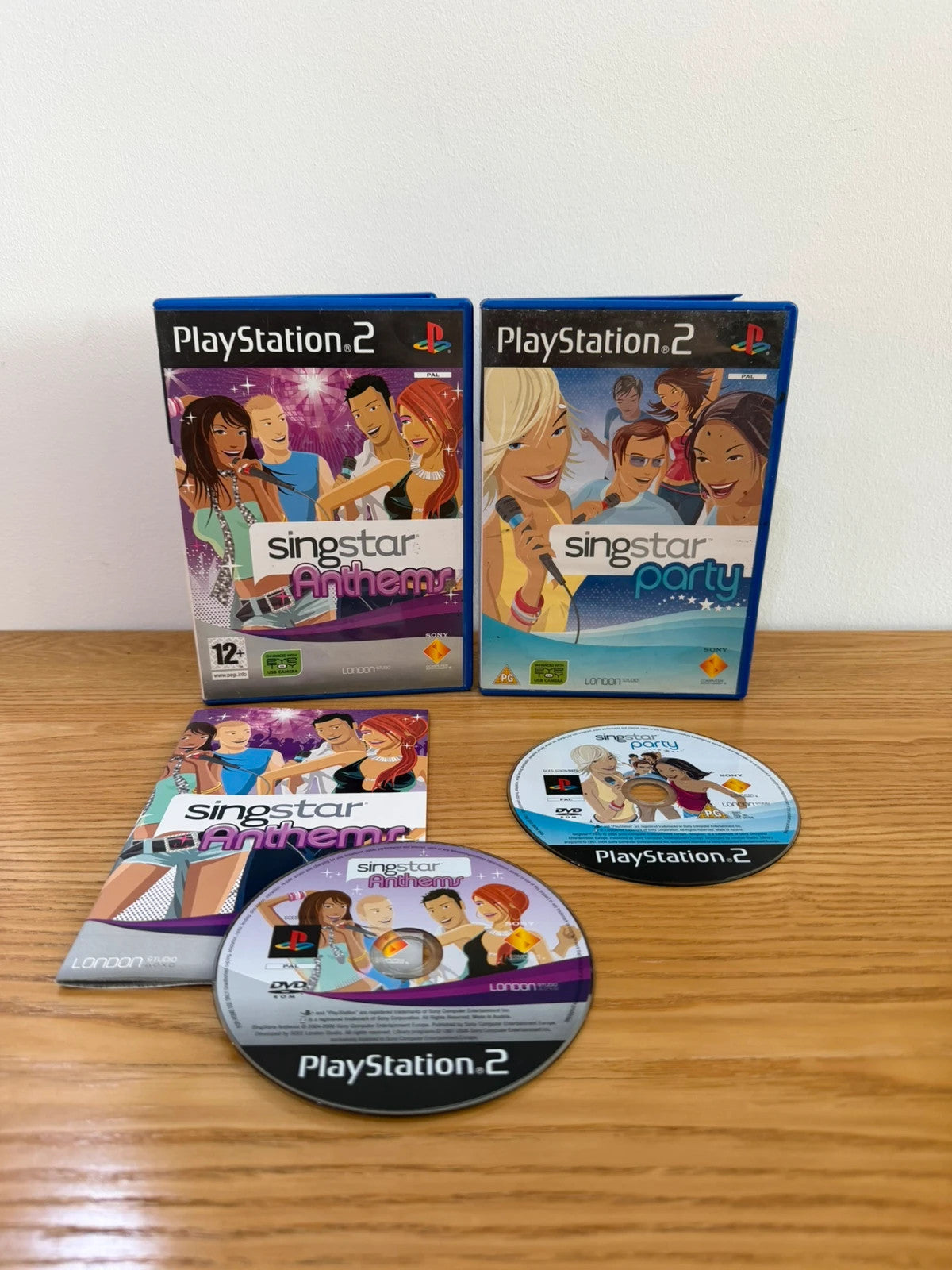 Wills SingStar bundle for PlayStation 2 with six games, microphone, and USB adapter.