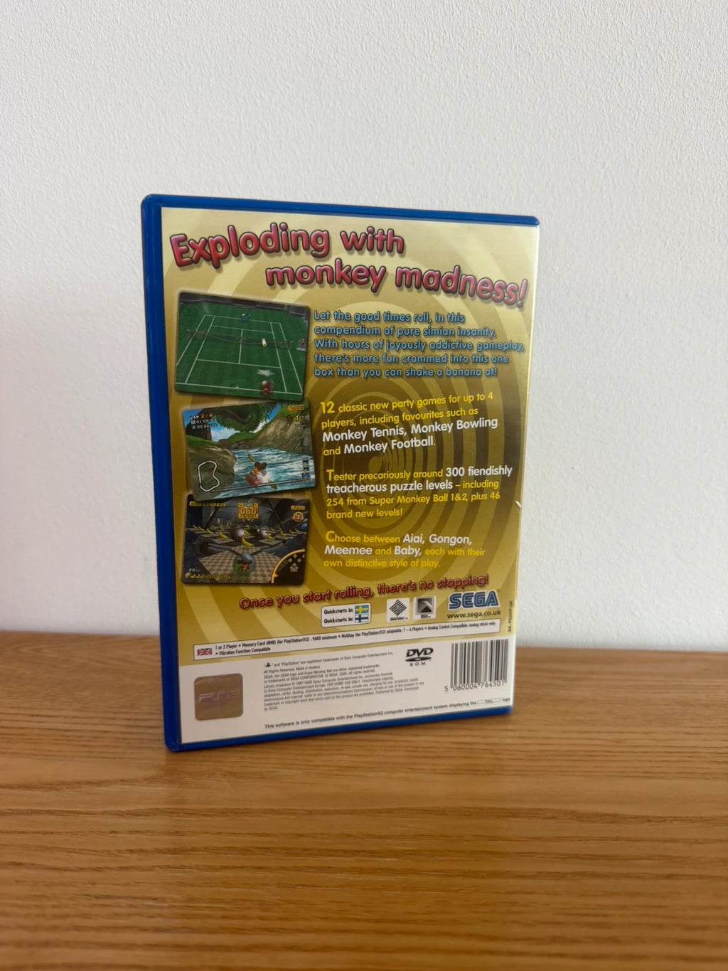 Multiples cream video game accessory with Super Monkey Ball Deluxe cover art and manual.