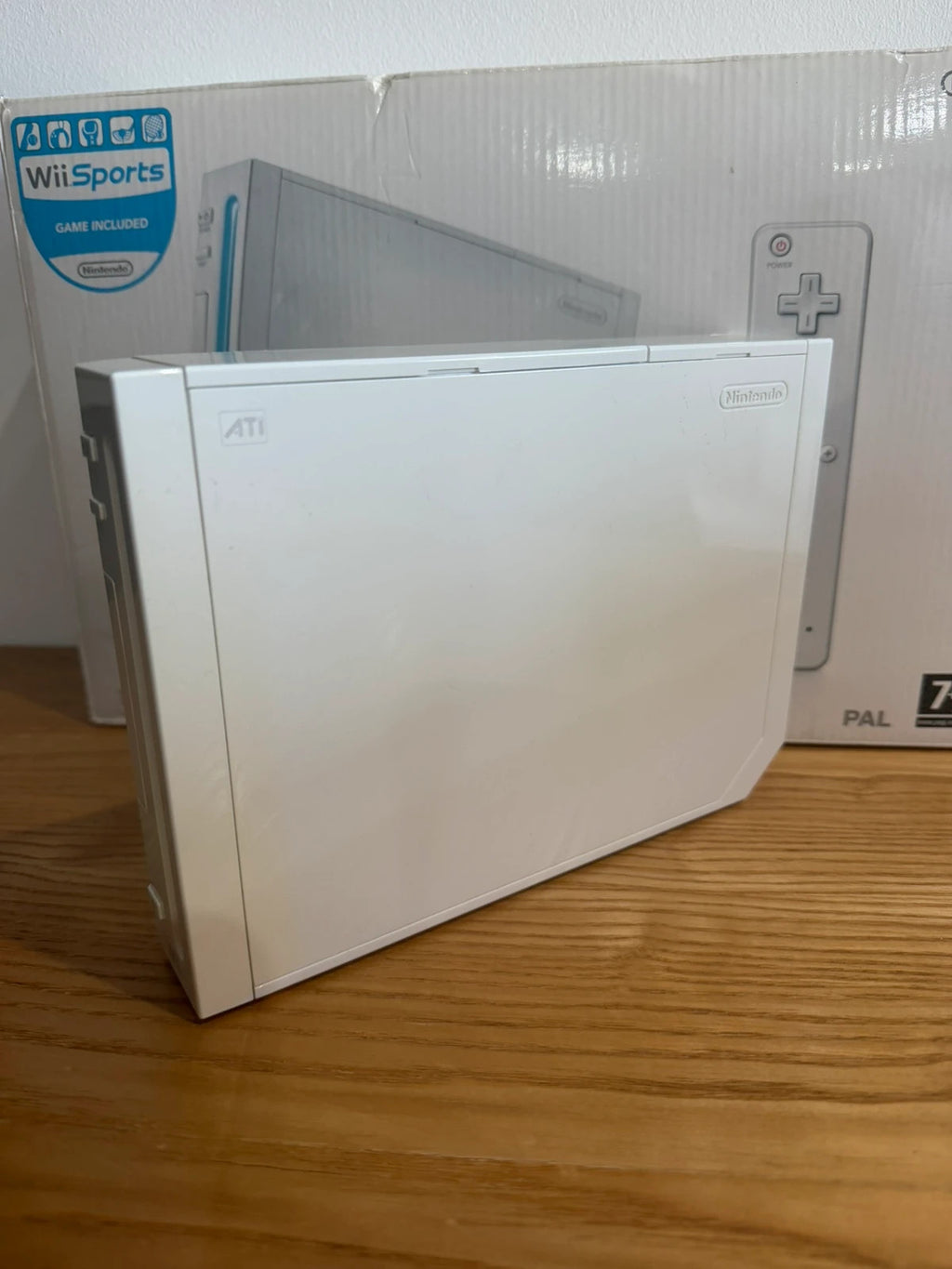 Nintendo white Wii console bundle with original box, remote, and accessories.