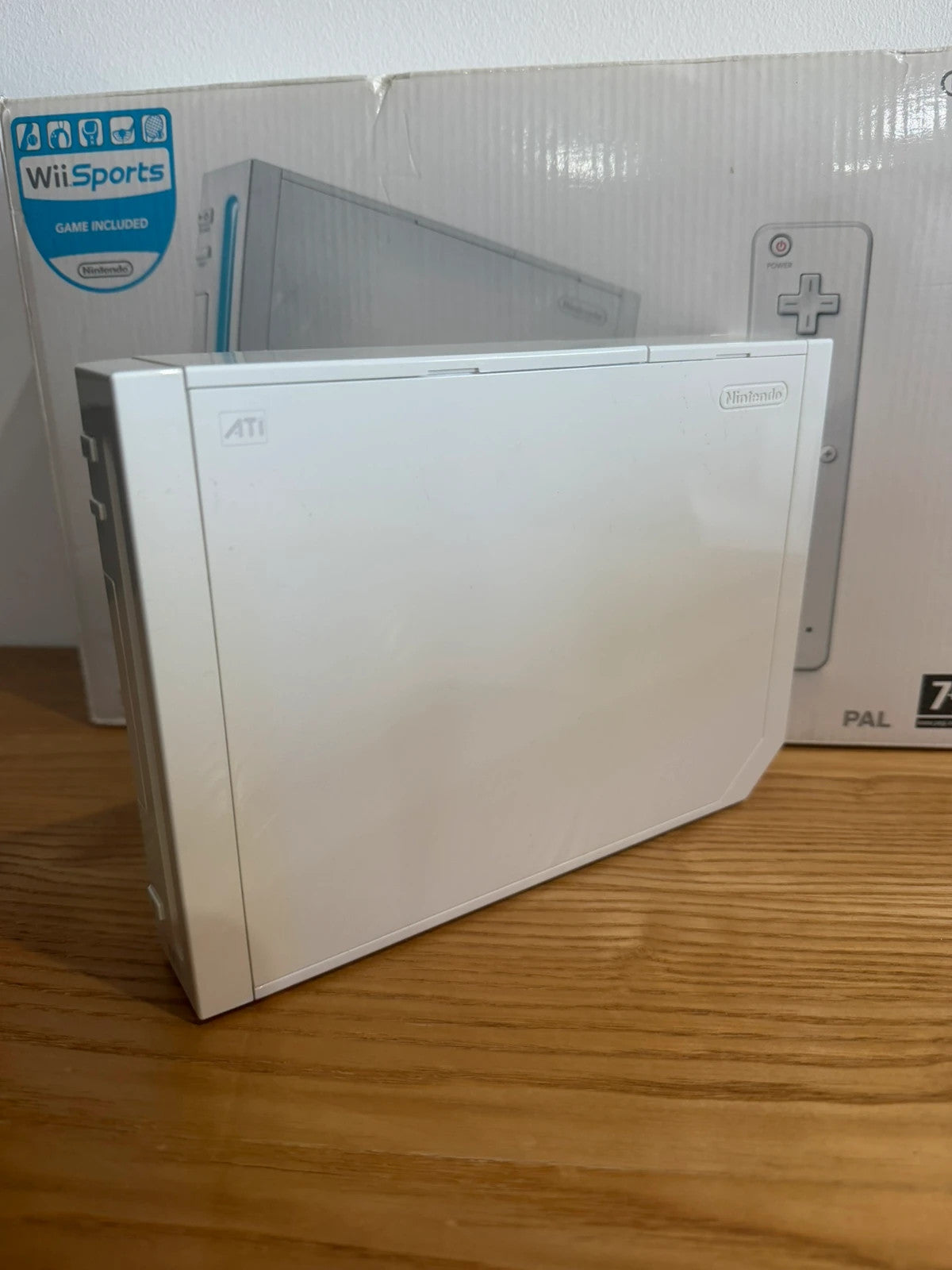 Nintendo white Wii console bundle with original box, remote, and accessories.