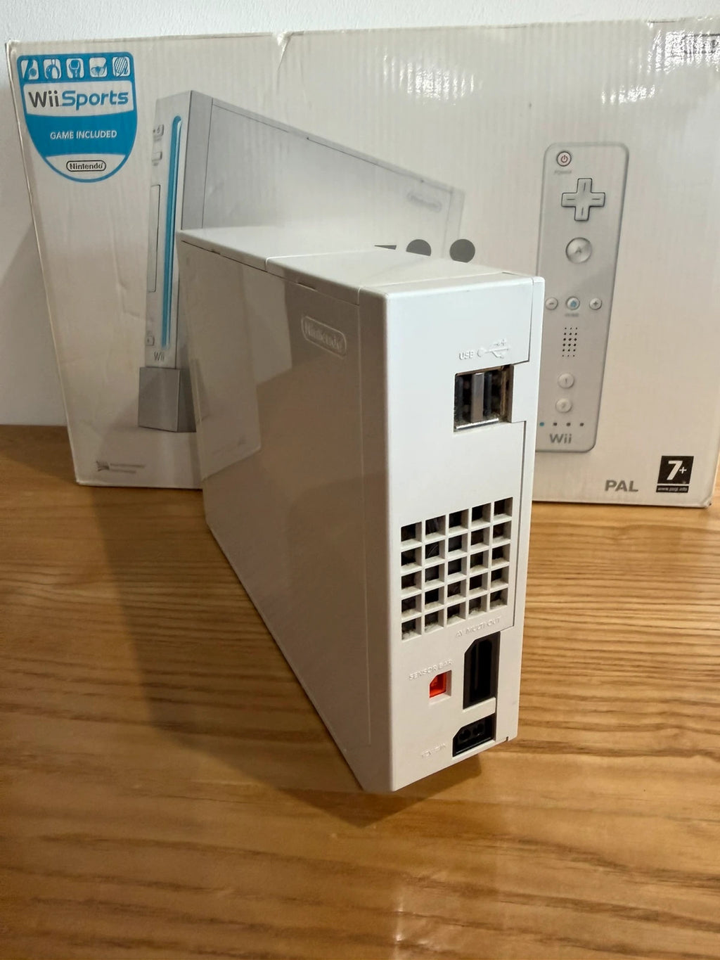 Nintendo white Wii console bundle with original box, remote, and accessories.