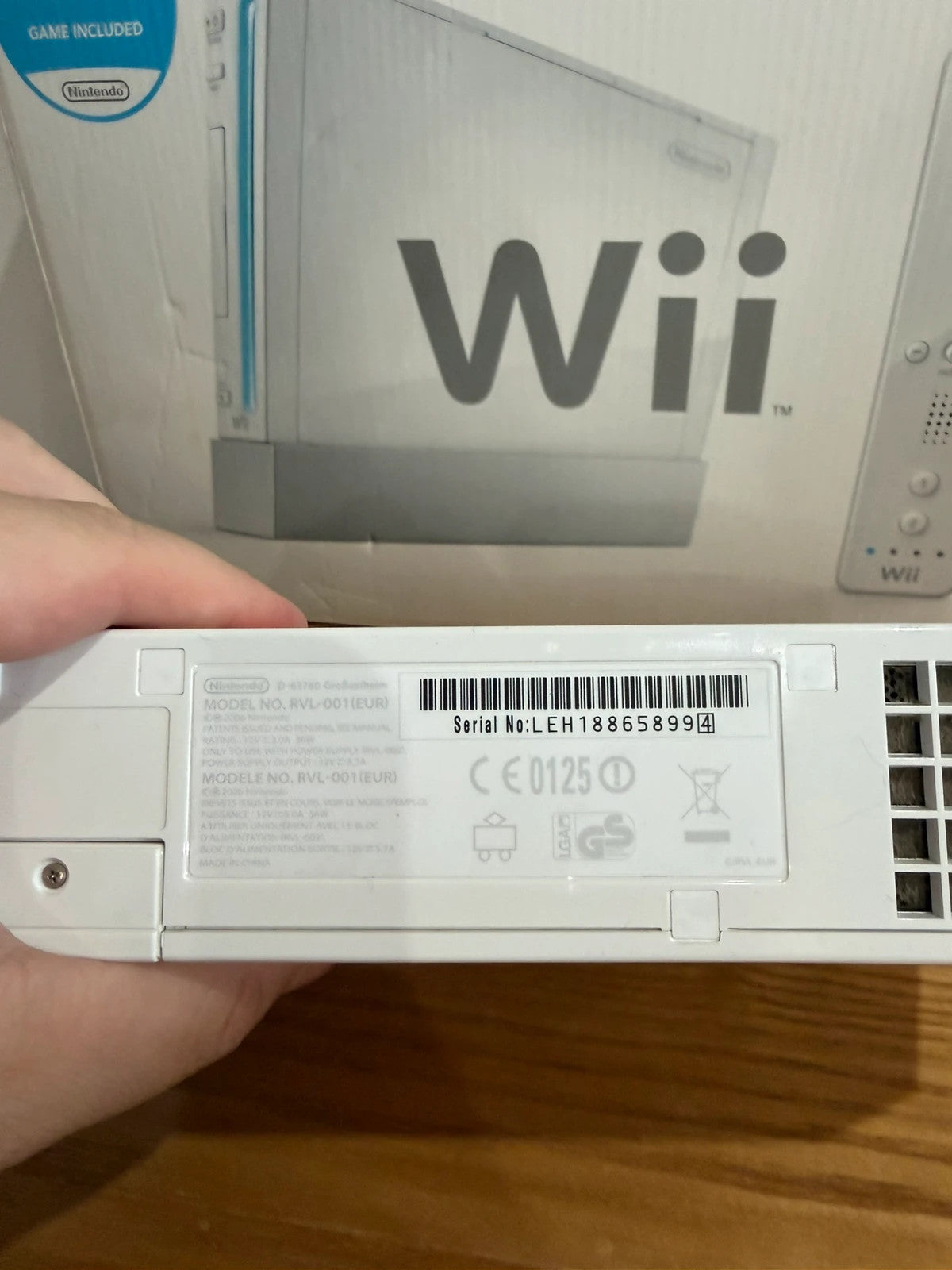 Nintendo white Wii console bundle with original box, remote, and accessories.