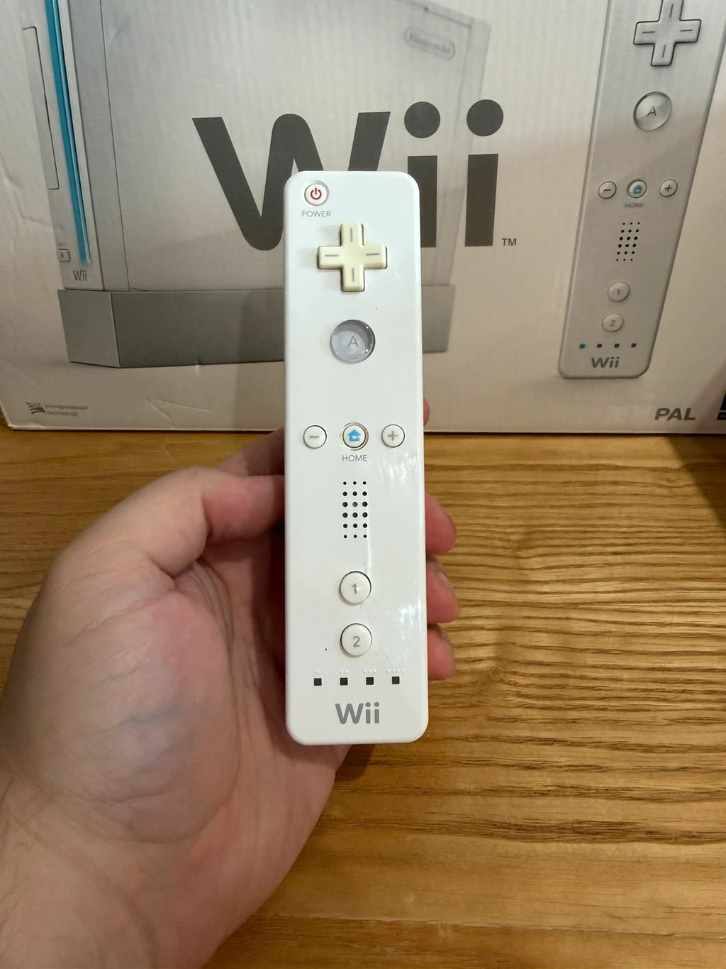 Nintendo white Wii console bundle with original box, remote, and accessories.