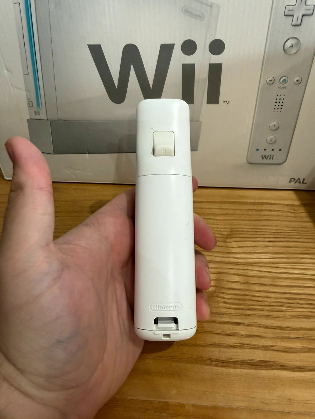 Nintendo white Wii console bundle with original box, remote, and accessories.