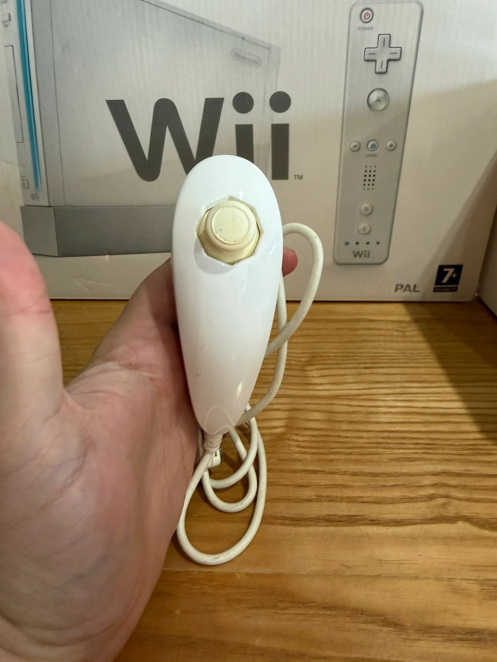 Nintendo white Wii console bundle with original box, remote, and accessories.