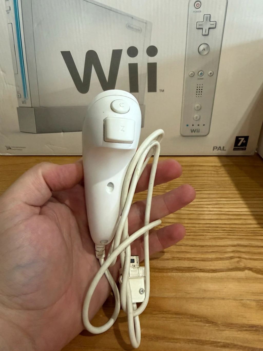 Nintendo white Wii console bundle with original box, remote, and accessories.