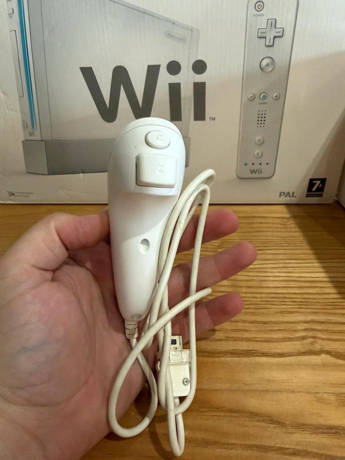 Nintendo white Wii console bundle with original box, remote, and accessories.