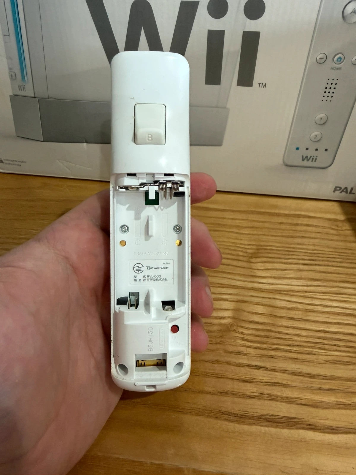 Nintendo white Wii console bundle with original box, remote, and accessories.