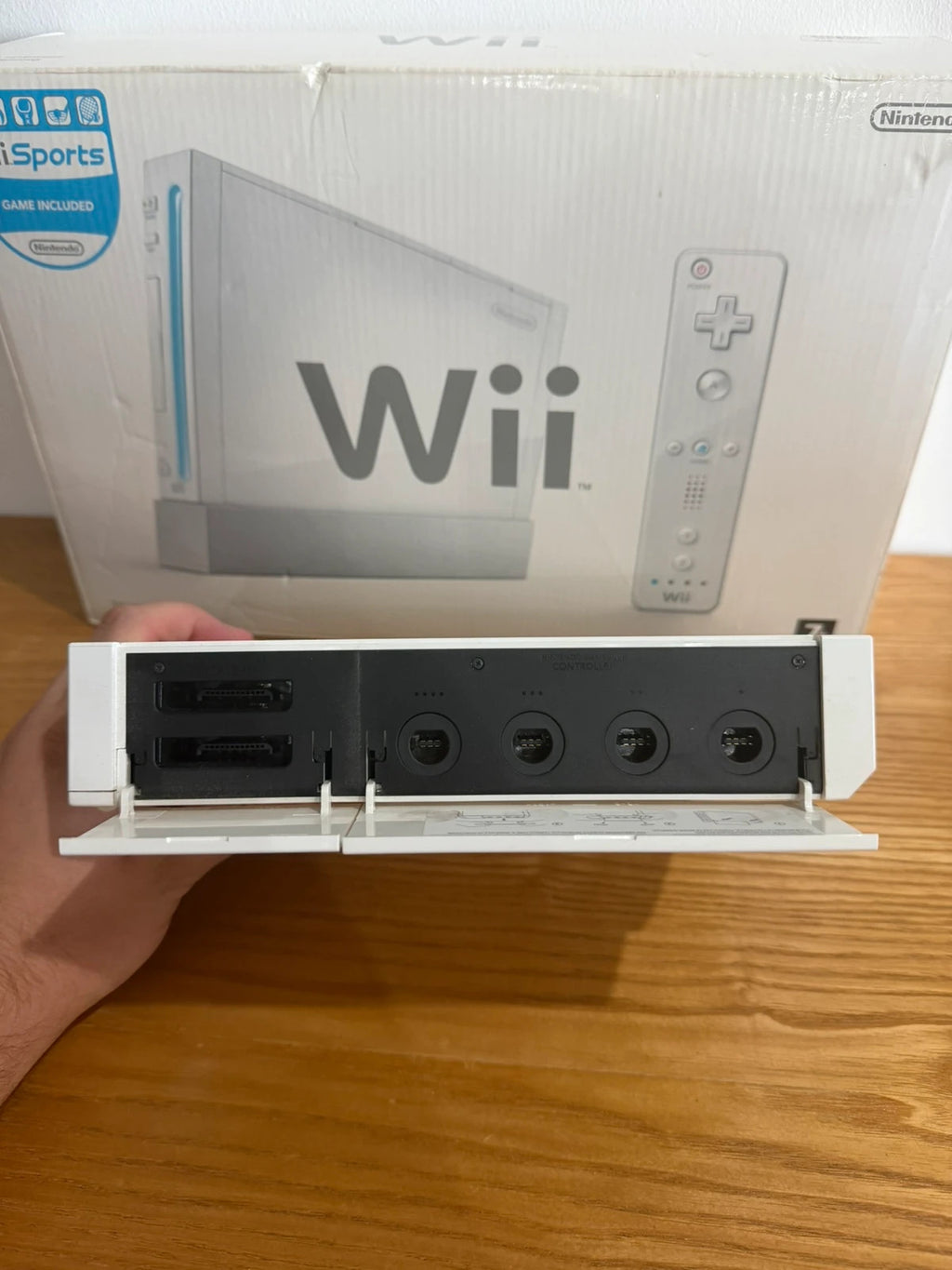 Nintendo white Wii console bundle with original box, remote, and accessories.