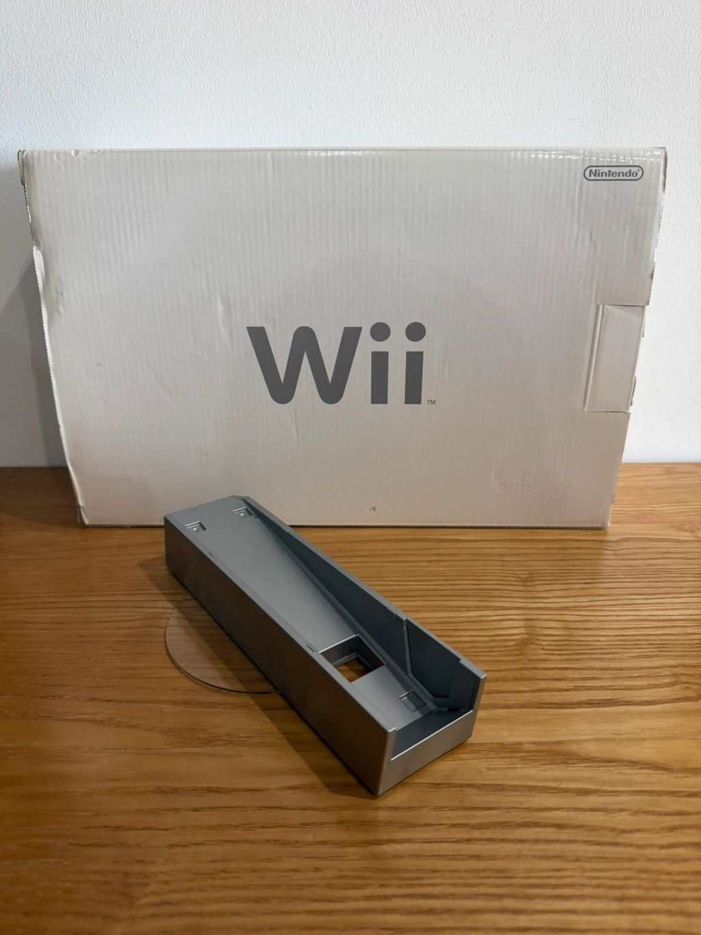 Nintendo white Wii console bundle with original box, remote, and accessories.