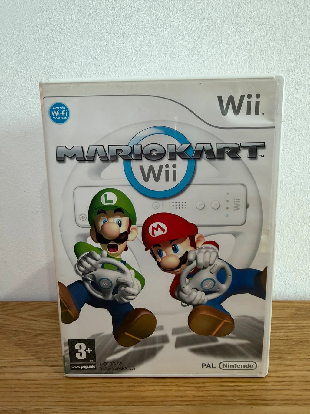 Nintendo Wii Mario Kart game bundle with manual and two steering wheels, very good condition.