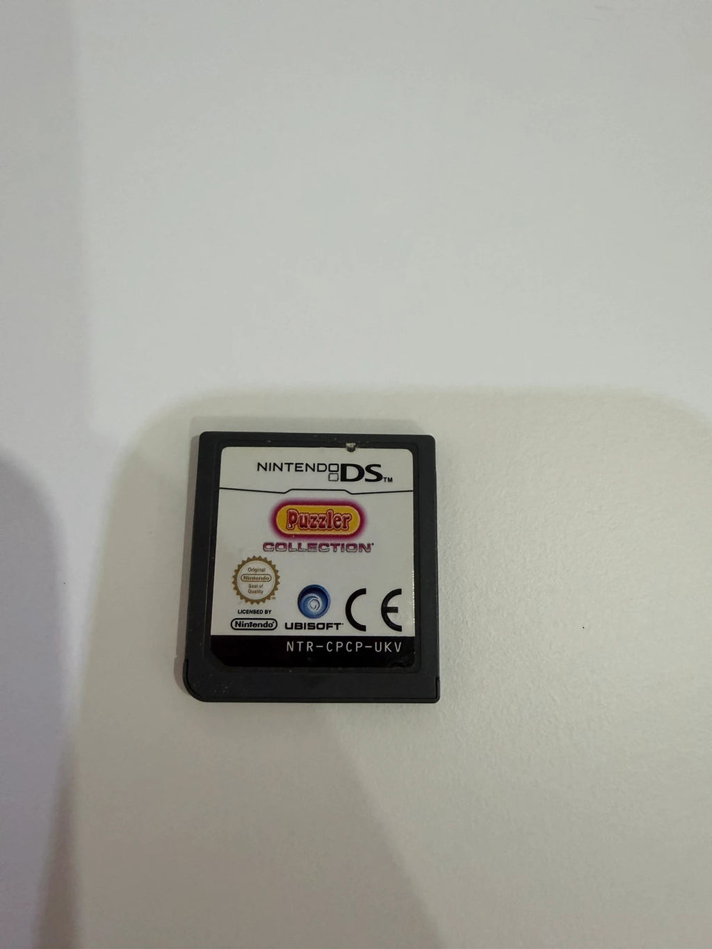 Puzzler Collection Nintendo DS game cartridge with minimal signs of use.