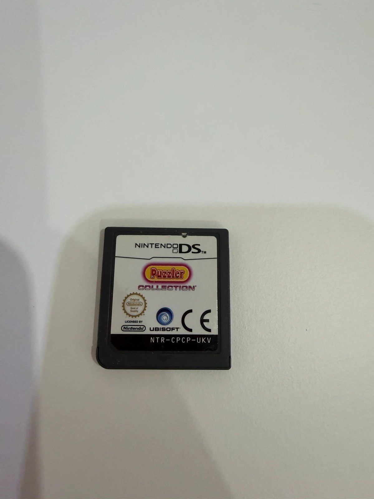 Puzzler Collection Nintendo DS game cartridge with minimal signs of use.