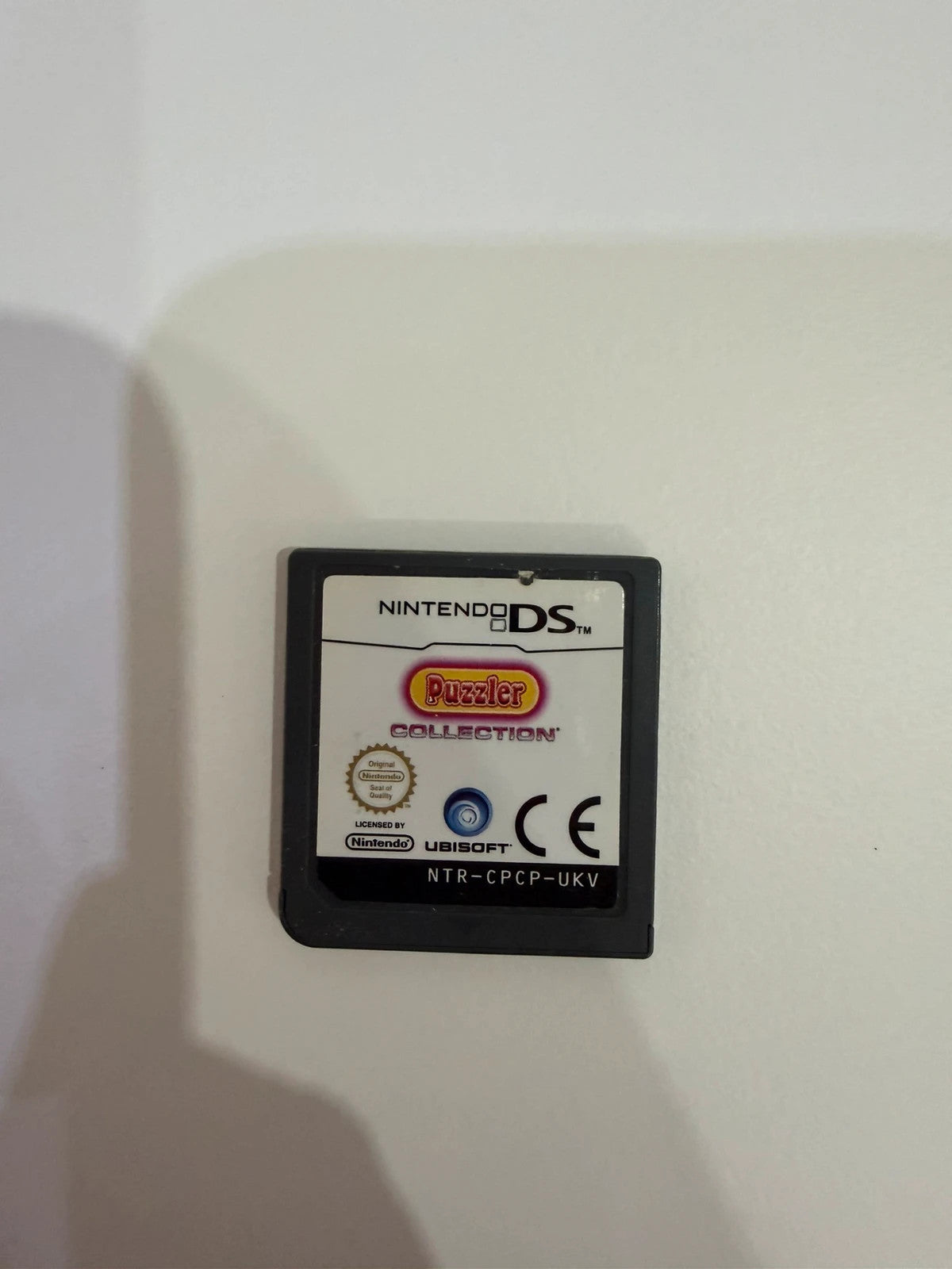 Puzzler Collection Nintendo DS game cartridge with minimal signs of use.