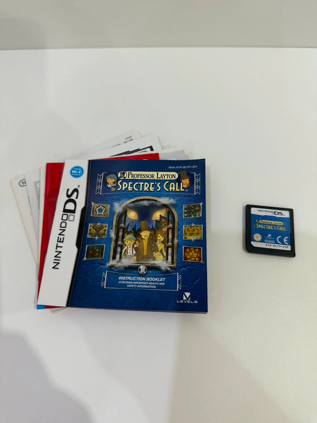 Professor Layton video game cream case with manual and cartridge, very good condition.