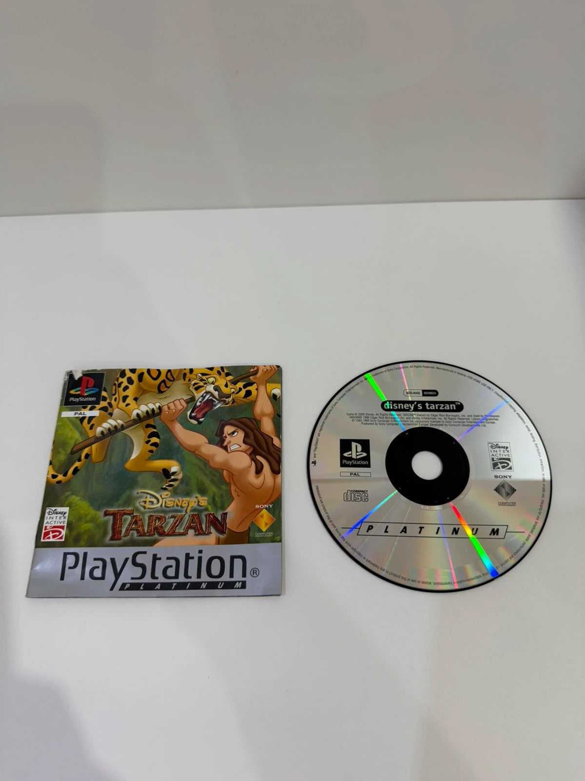 Disney Tarzan Platinum Edition PS1 game case with manual and disc, very good condition.