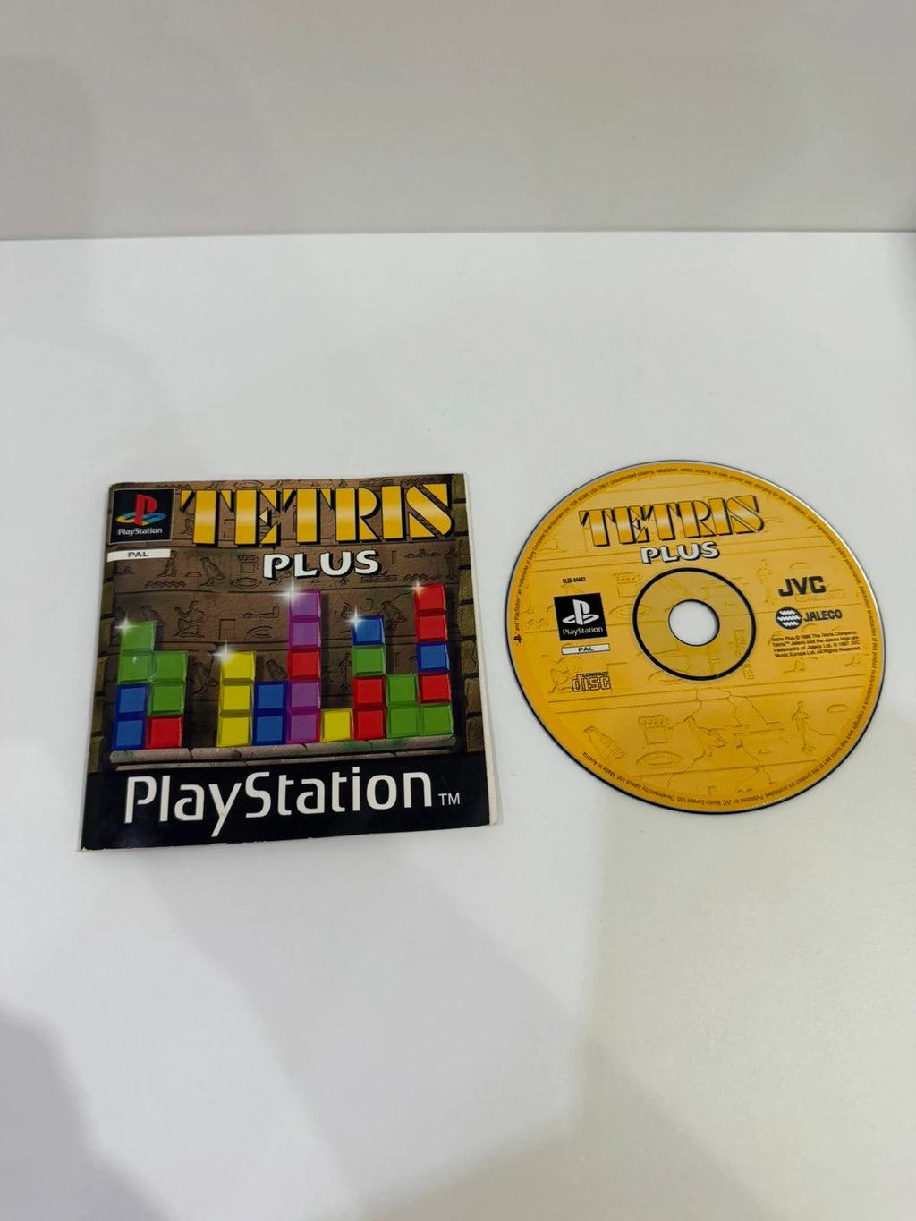 Tetris Plus PS1 video game disc and case with visible crack, no front inlay.
