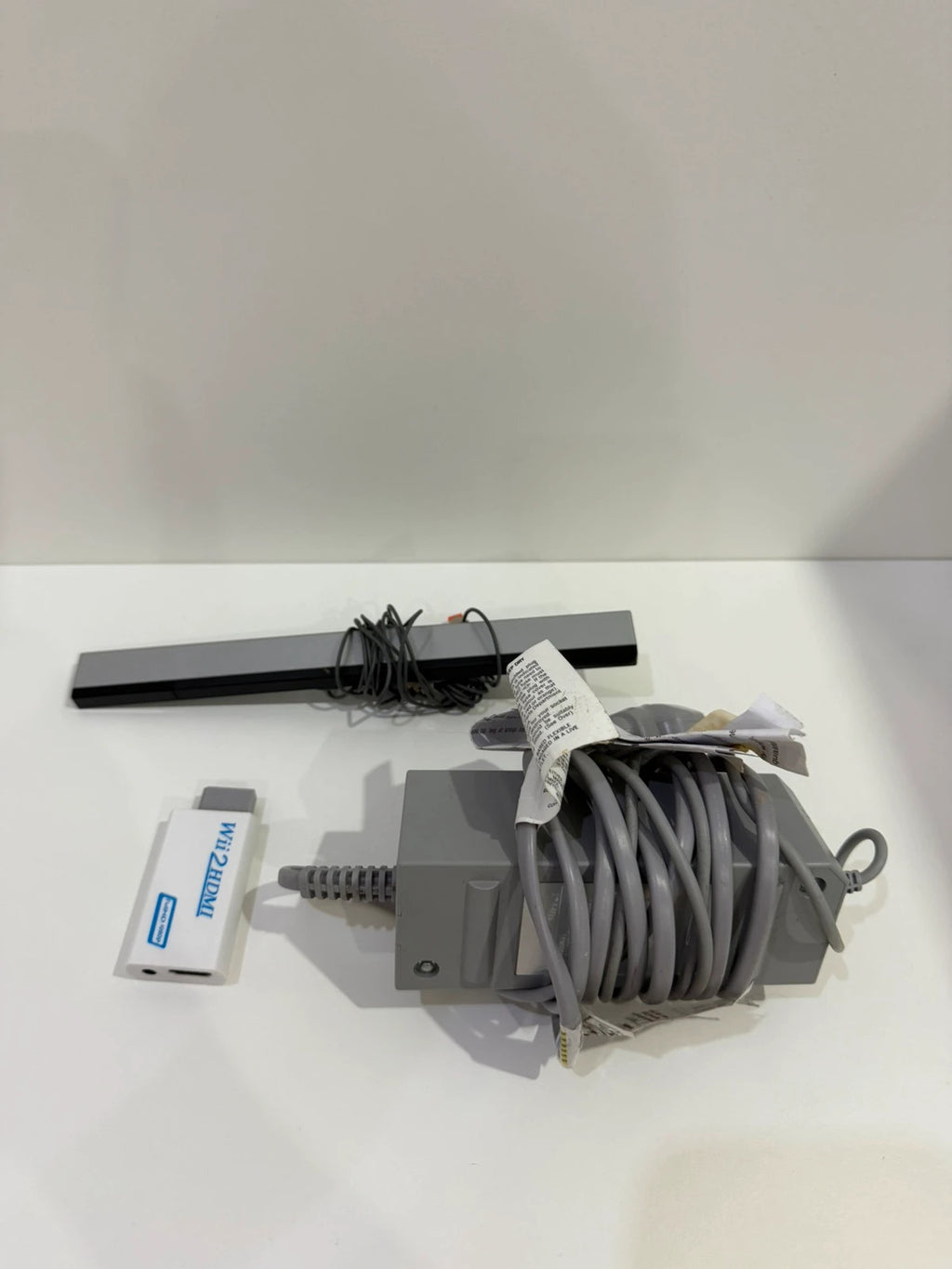Nintendo black Wii console bundle with official accessories and Wii2HDMI adapter.