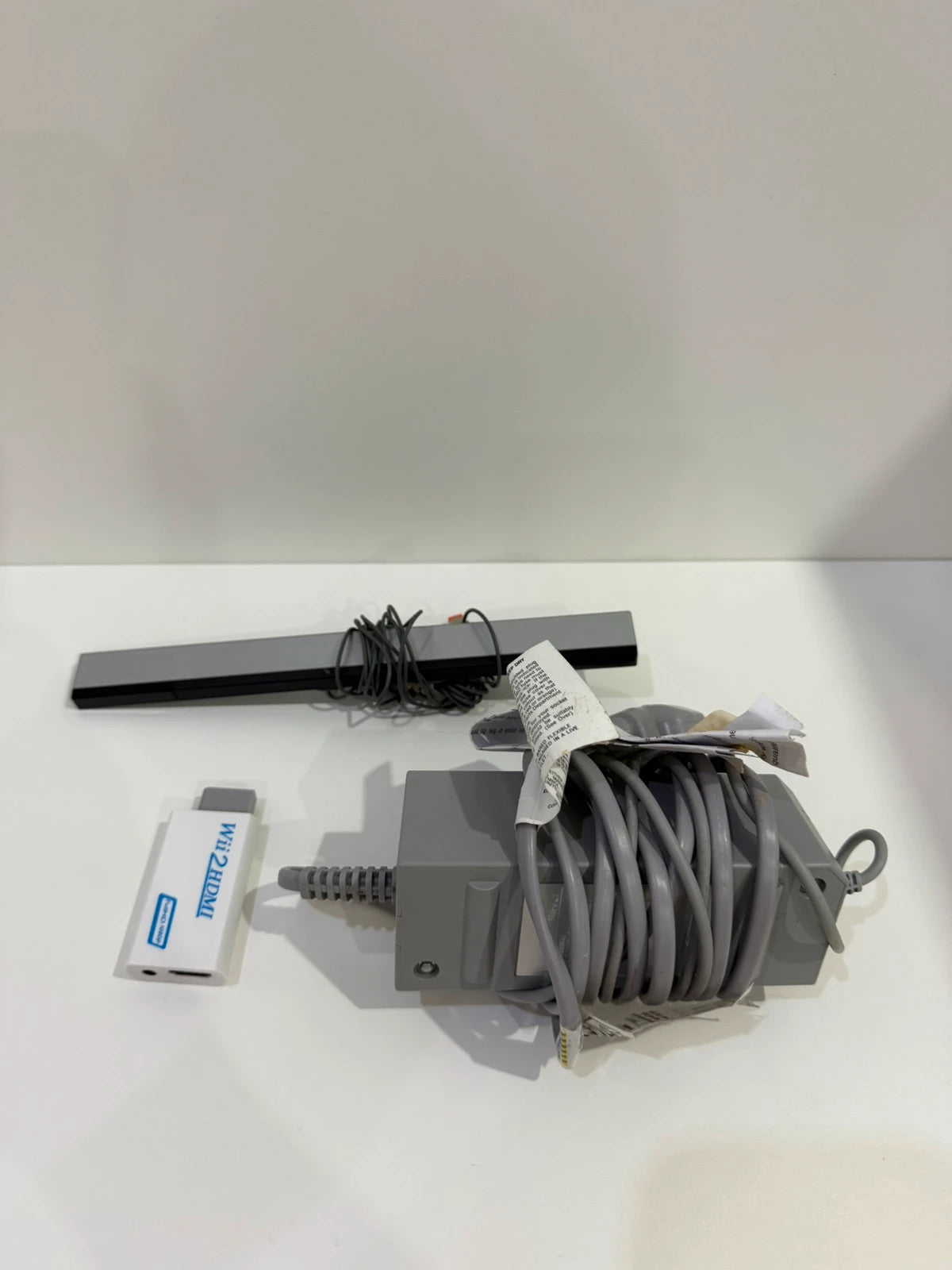 Nintendo black Wii console bundle with official accessories and Wii2HDMI adapter.