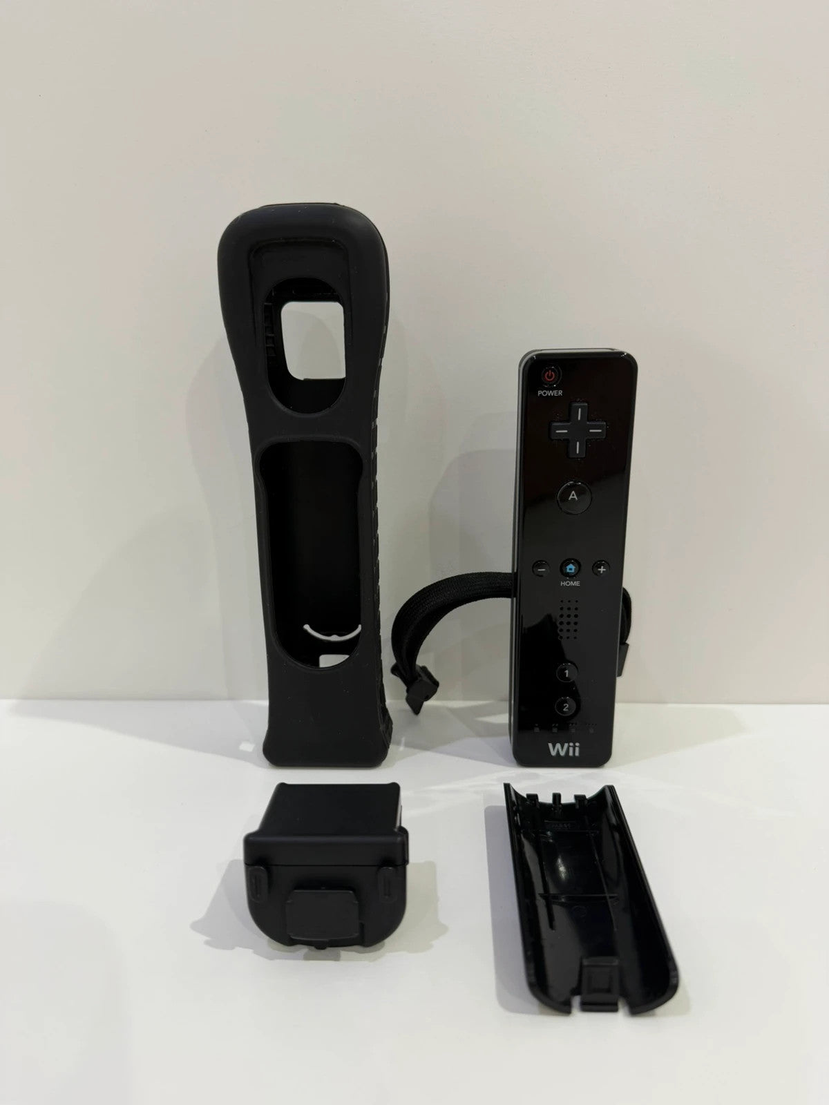 Nintendo black Wii console bundle with official accessories and Wii2HDMI adapter.