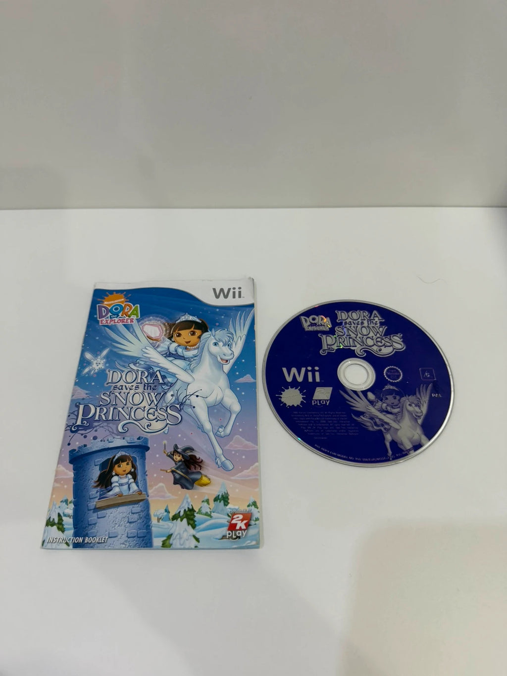 Dora Saves The Snow Princess Nintendo Wii game case with colorful cover art and manual.