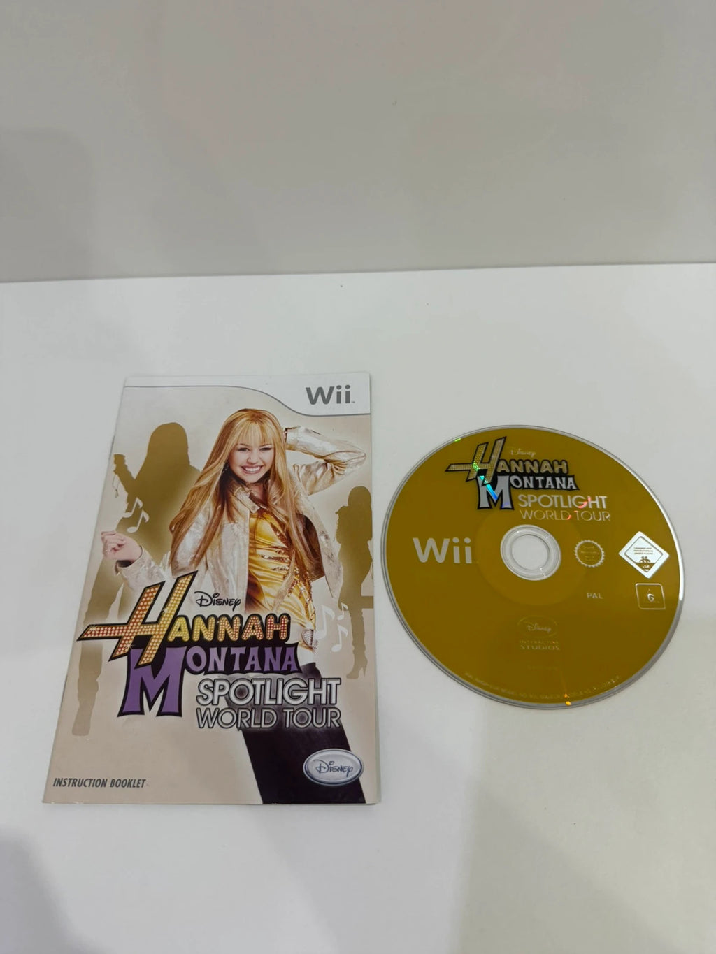 Hannah Montana Spotlight World Tour cream Nintendo Wii game with manual and cover art.
