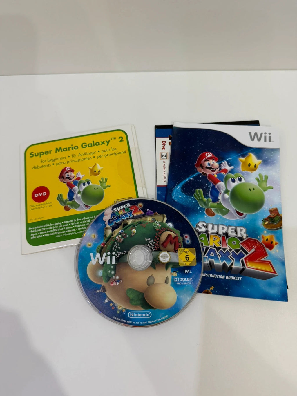 Super Mario Galaxy 2 Nintendo Wii game complete with manual, cardboard sleeve, and sealed DVD.