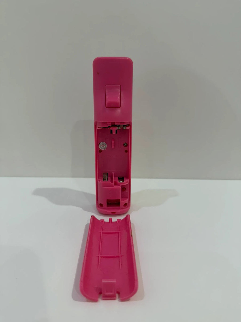 Value pink Wii compatible remote and nunchuk set with ergonomic design and buttons.