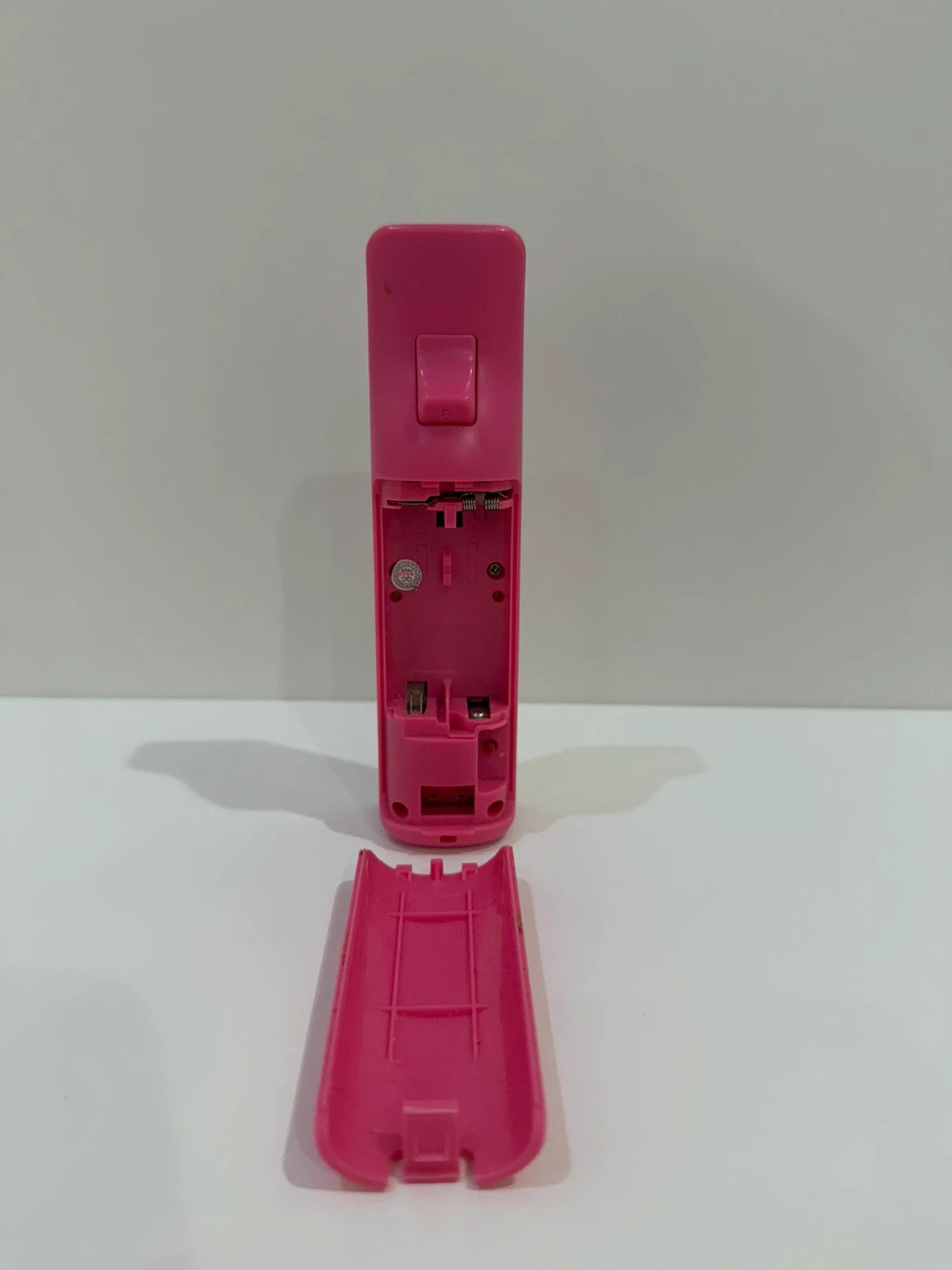 Value pink Wii compatible remote and nunchuk set with ergonomic design and buttons.