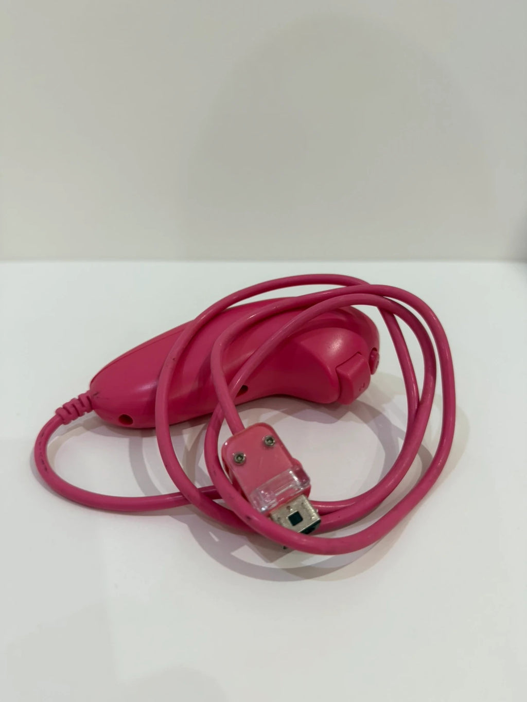 Value pink Wii compatible remote and nunchuk set with ergonomic design and buttons.