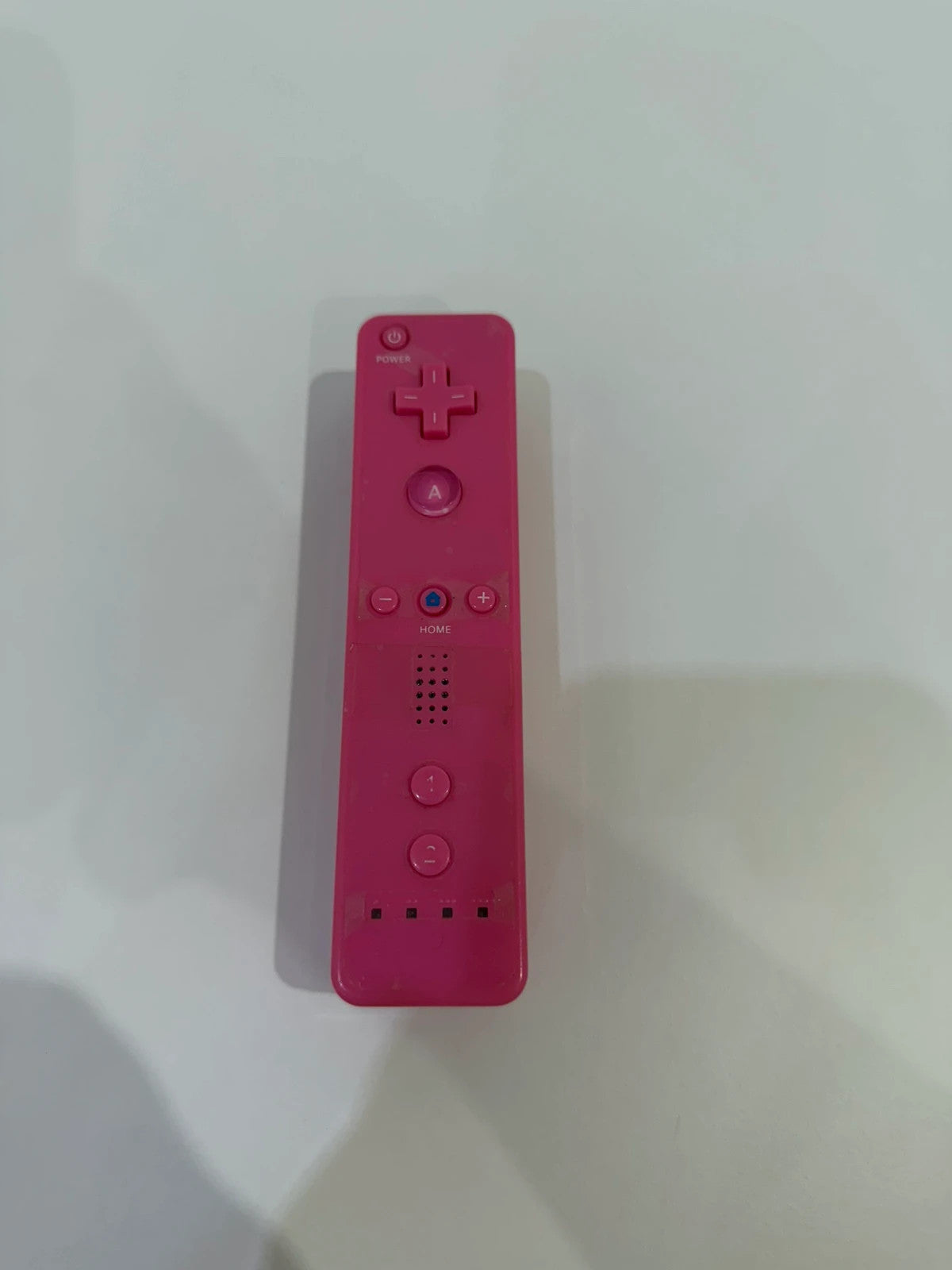 Value pink Wii compatible remote and nunchuk set with ergonomic design and buttons.