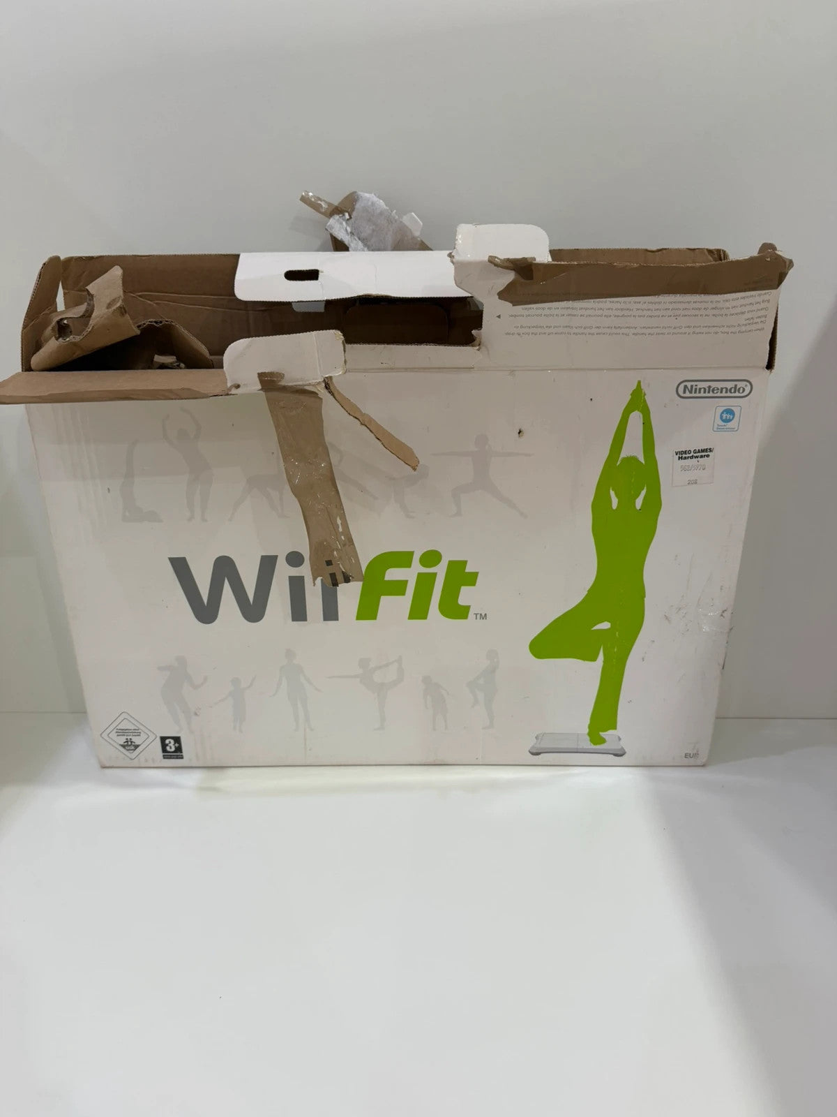 Nintendo Wii Fit Balance Board white with original box, game discs, and booklets.