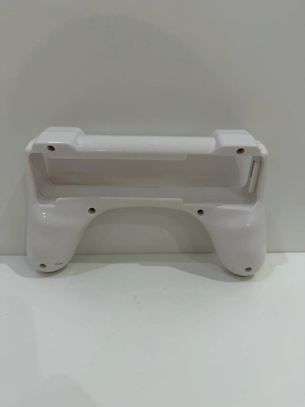 Value white Wii remote attachment with ergonomic design and compatibility for Nintendo Wii.
