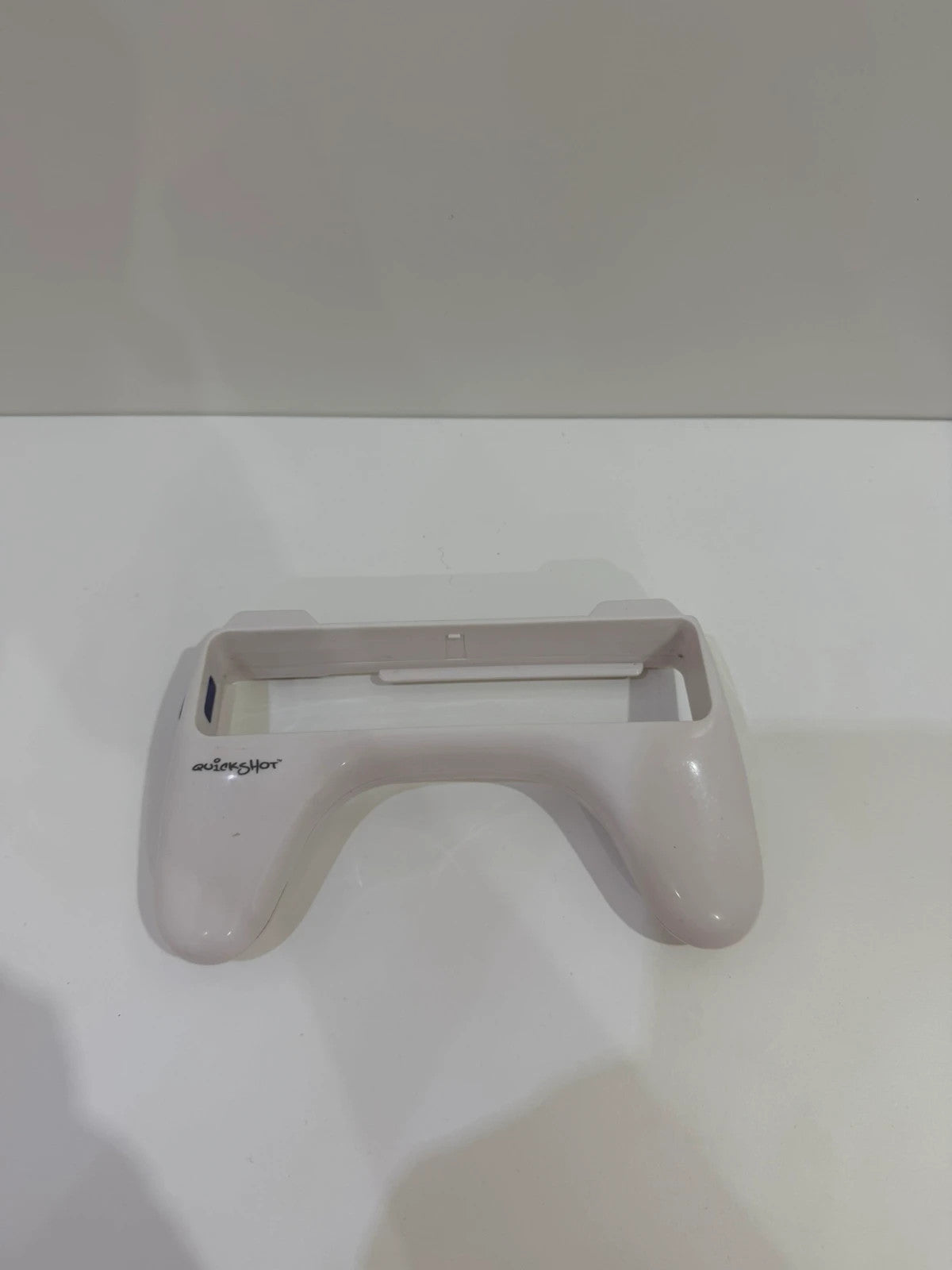 Value white Wii remote attachment with ergonomic design and compatibility for Nintendo Wii.