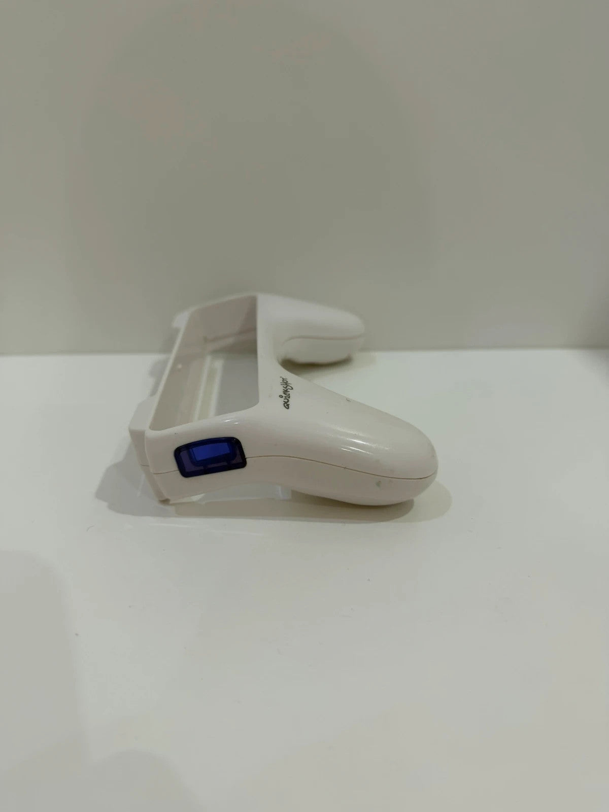 Value white Wii remote attachment with ergonomic design and compatibility for Nintendo Wii.