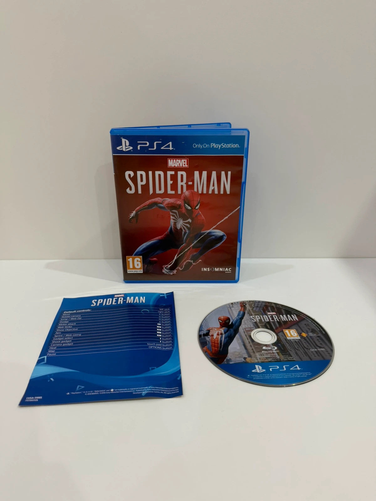 Marvel’s Spider-Man PS4 game case with disc, manual, and vibrant cover art.