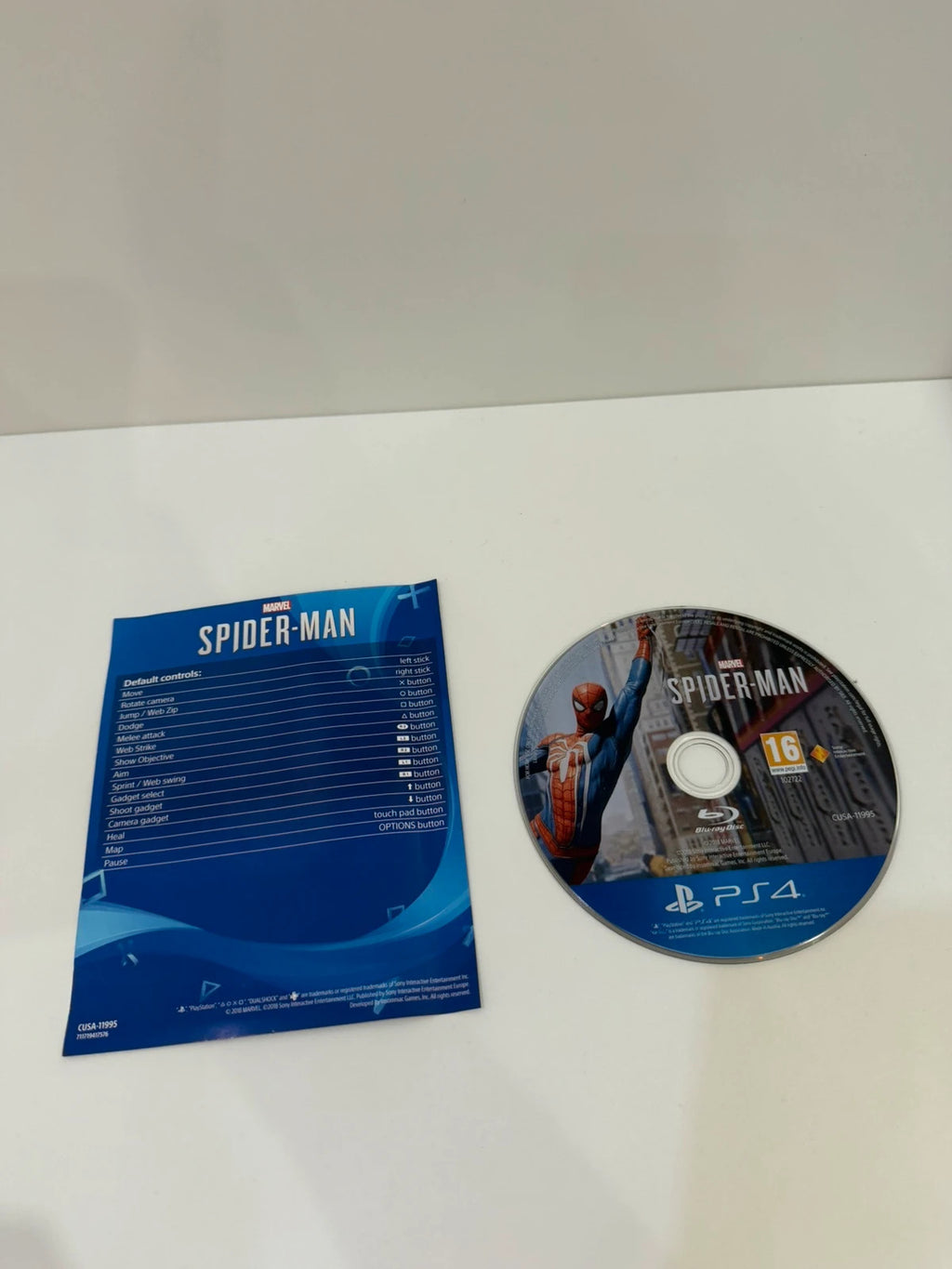 Marvel’s Spider-Man PS4 game case with disc, manual, and vibrant cover art.