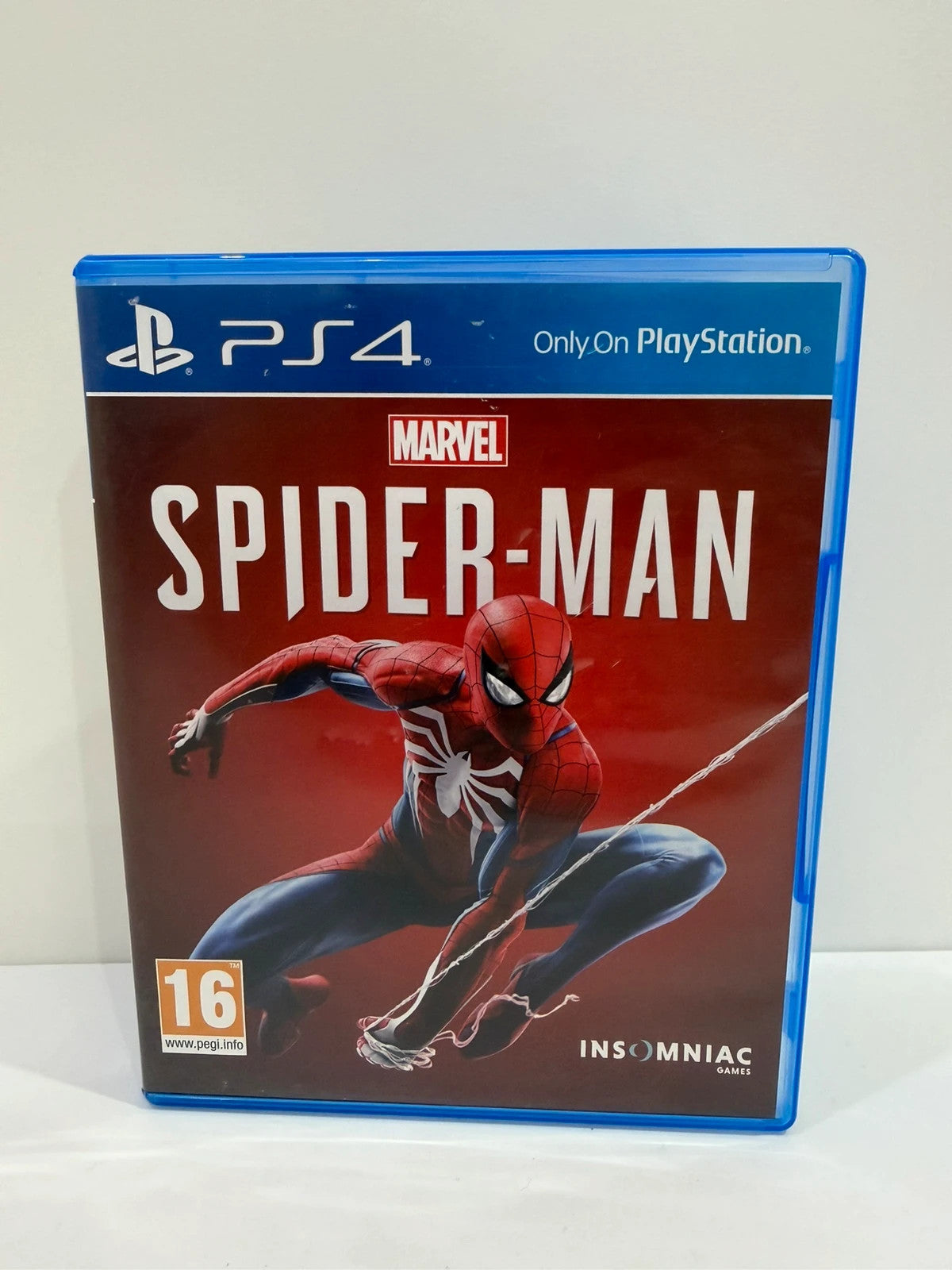 Marvel’s Spider-Man PS4 game case with disc, manual, and vibrant cover art.
