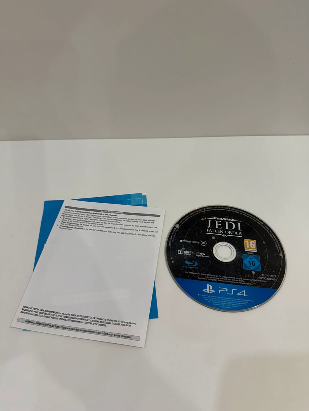 Star Wars Jedi Fallen Order PS4 game disc and case with vibrant cover art.