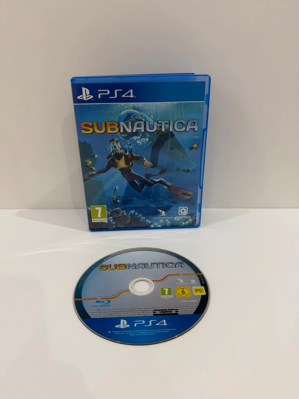 Subnautica PS4 game disc and case with vibrant underwater cover art.