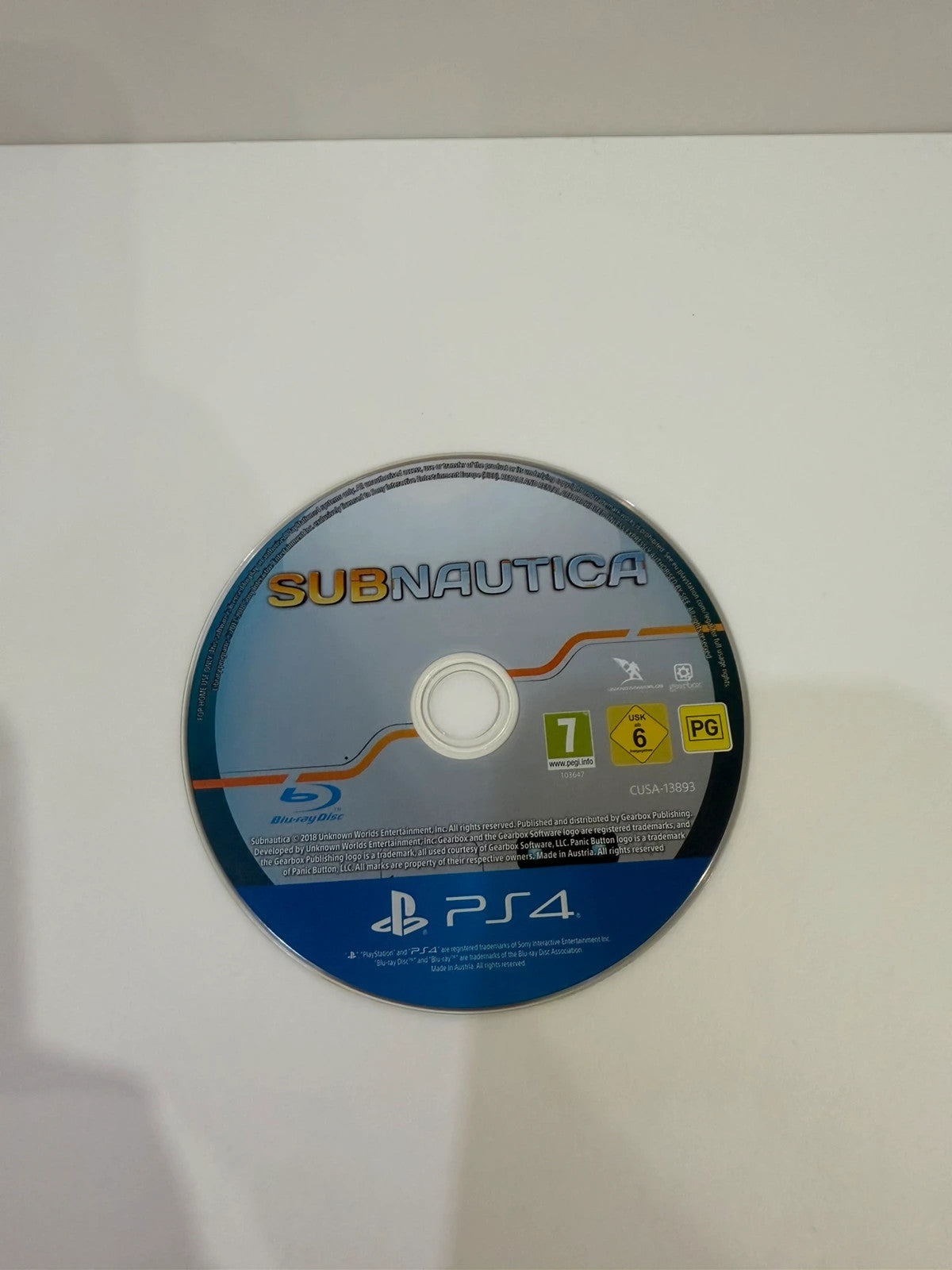 Subnautica PS4 game disc and case with vibrant underwater cover art.