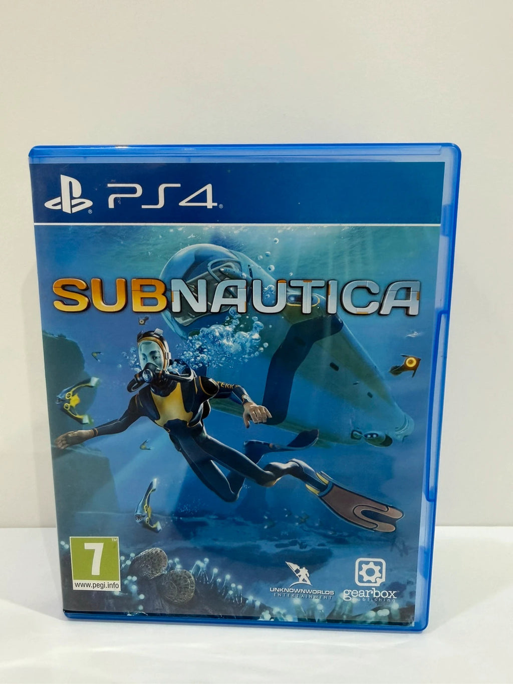 Subnautica PS4 game disc and case with vibrant underwater cover art.
